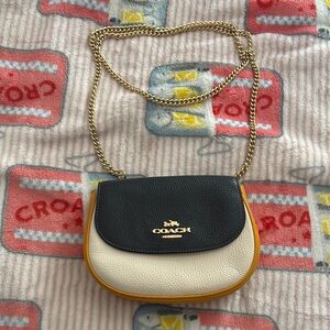 Coach Elegant Black and Cream Crossbody Bag with Gold Accents
